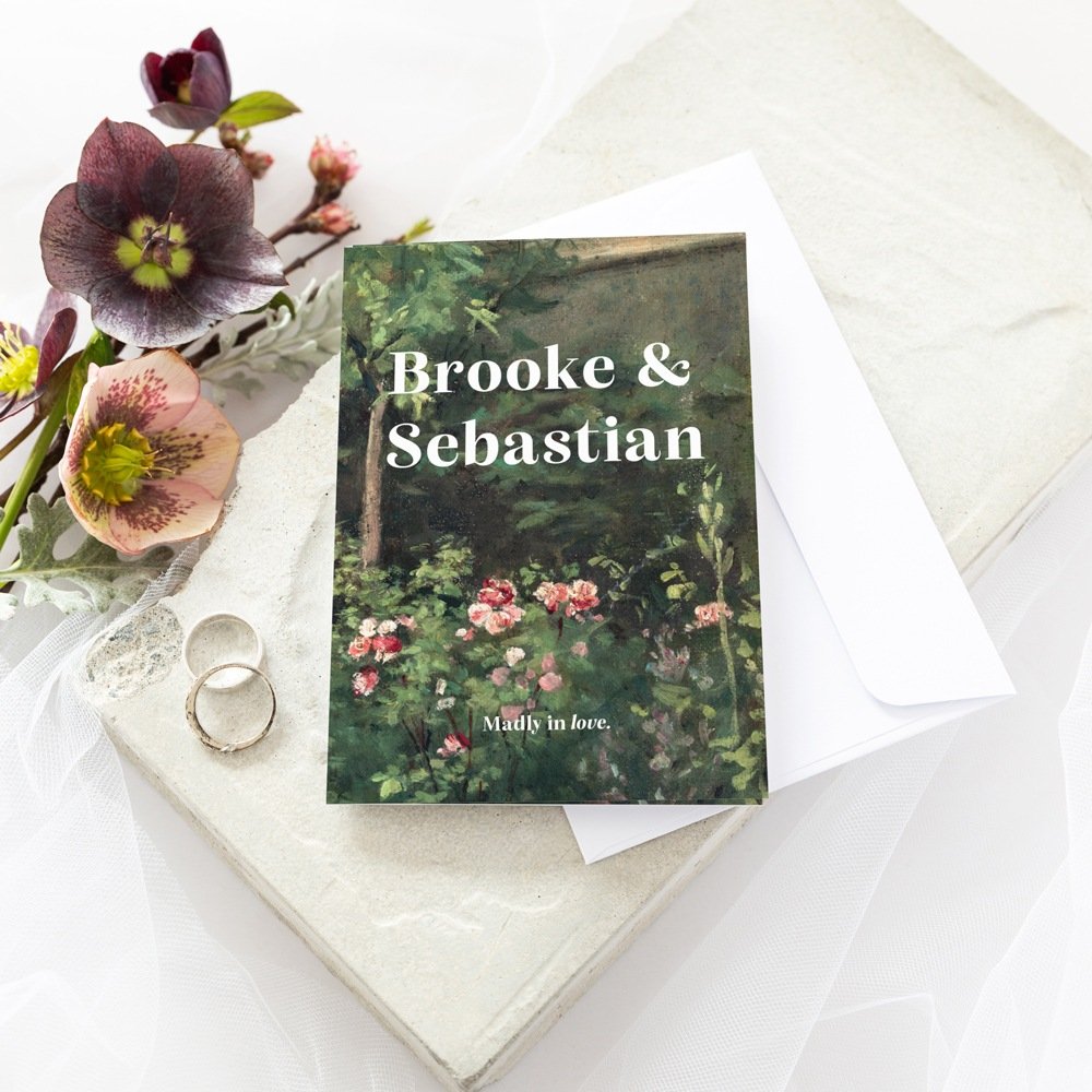 wedding invitation with deer antlers next to white ribbon